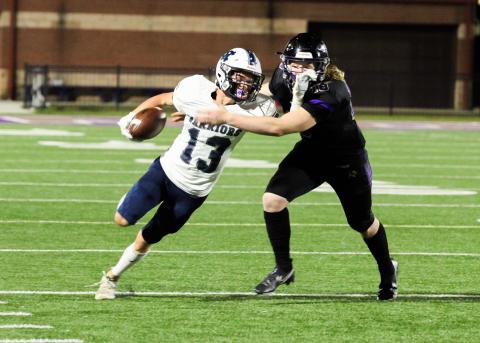 Colton Turner, left, tries to pull away from Lumpkin County's Cooper Scott after recovering a fumble during the Warriors' region win last Friday night in Dahlonega. (Photo/Staci Sulhoff)