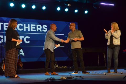 From left, Fellowship of Christian Athletes area representative John Luna shakes hands with The Bridge Lead Pastor Patrick Ballington. (Photo/Wayne Hardy)