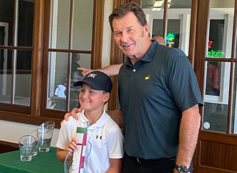 Hudson Justus, left, is shown with Master's champion Nick Faldo after winning the 10U division title last week at the Faldo Hurricane Series 2021 Grand Final. (Photo/Scott Justus)