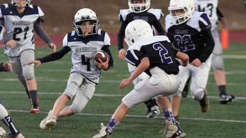 Lane Bray looks for some running room during the fifth grade game against Gilmer County. (Photo/Mark Turner)
