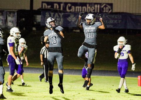 Bryson Cronic, left, and Darius Cannon celebrate after a touchdown during the Warriors' region win over Gilmer County last Friday in Cleveland. (Photo/Staci Sulhoff)