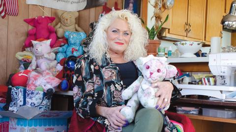 Laura Southerland holds one of the memorial teddy bears she creates for clients using the garments of loved ones who have died. She says demand for the keepsakes have continued to rise. (Photo/Ashley Blair)