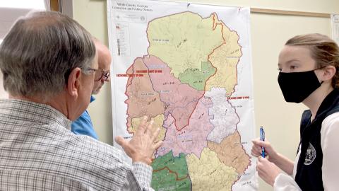 White County Elections Director Akyn Bailey, right, speaks with White County Board of Elections and Registration members (from left) Dwayne Turner and Todd Marks about precinct line updates at a Dec. 6 meeting. (Photo/Wayne Hardy)