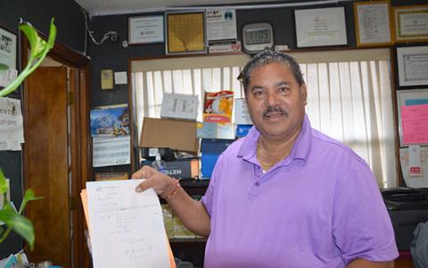 Sam Patel, owner of the Knights Inn in Cleveland, displays a receipt for new windows installed in some of the motel’s rooms. (Photo/Linda Erbele)