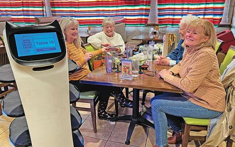 Bella waits on Susan Holmes, Missy Whitlock, Jaymi Hampton and Patricia Noell as they  celebrate a birthday. (Photo/Linda Erbele)