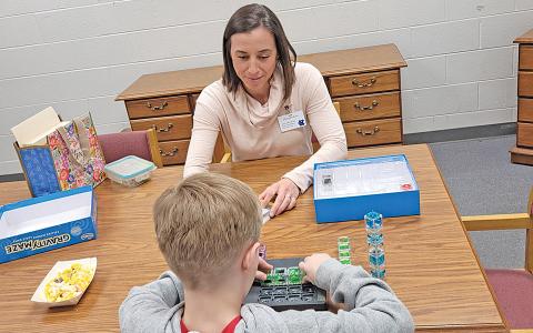 Haley Hobson plays with the young boy she mentors as they talk. (Photo/submitted)