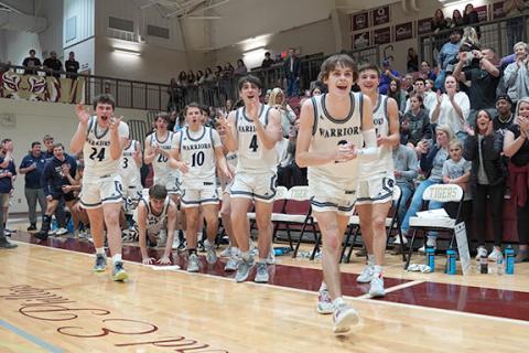 Members of the White County High School basketball team celebrate as they head on the court to receive the Region 7-AAA championship trophy. 