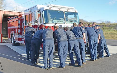 Firefighters from around the county push Engine 2 into a bay at White County Station 2. (Photos/Samantha Sinclair)