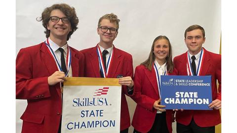 Warrior TV students Ethan Ankava, Daniel Ratigan, Maggie Anglin, Griffin DeFoor celebrate winning first place in Video News Production.