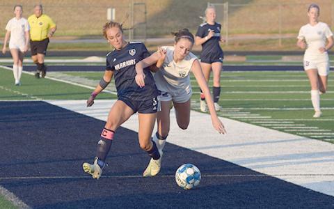 Hazen Ramey, left, battles Lumpkin County's Savannah Buck for control of the ball during the second half of the region matchup last week at Warrior Stadium. (Photo/Mark  Turner)