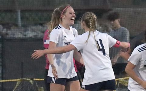 Callie Armour, left, celebrates with Anna Tatum after scoring an overtime goal that gave the Lady Warriors a 1-0 win over Hebron Christian last week in the opening round of the Class AAA state soccer tournament last week.  (Photo/Mark Turner)