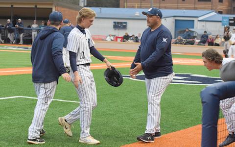 WCHS coaches Erick Stahl, left, and Jason Norton congratulate Shelton Ramey after his two-run double in the fifth inning gave the Warriors a 4-1 lead over West Hall. (Photo/Mark Turner)