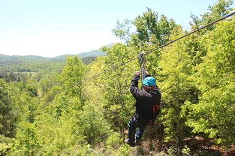 Leon White goes down “The Intimidator,” a half mile long zip line at Nacoochee Adventures with views of Mt. Yonah. (Photo/Jessica Wood)
