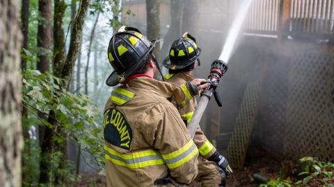 White County Firefighters and EMTs Frank Tirino and Jeffery Johansen work together to control the fire. (Photo/submitted)