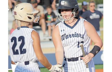 Emma Hare, left, congratulates Gabby Whiddon after scoring a run in sixth inning during the region win Monday over West Hall. (Photo/Mark Turner)