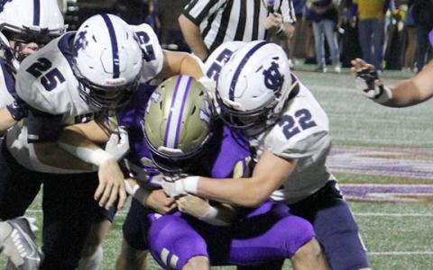 Bryce Dockery, No. 25, and Jason Rewis, No. 22, take down Lumpkin Coun- ty's Mason Sullens during the region game. (Photo/Mark Turner)