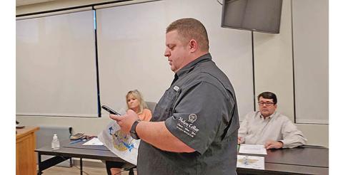 Justin Whitmire approaches the Cleveland Alcohol Review Board to show what he saw when zooming in on the city’s map. (Photo/Samantha Sinclair)