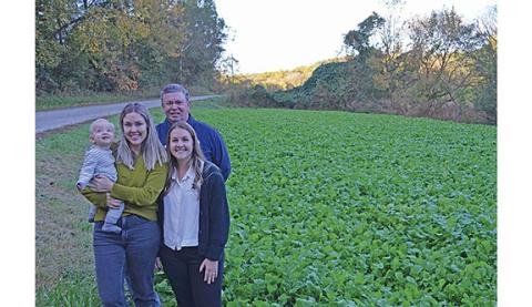 Marci Brown with Finn, Charlie Thomas and Haley Thomas are ready to welcome folks to gather turnip greens at their field on Charlie Thomas Road. (Photo/Samantha Sinclair)