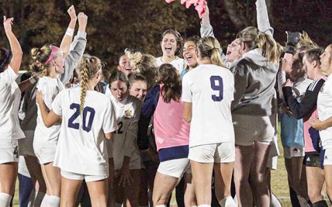 The members of the Truett McConnell women's soccer team celebrate moments after posting a 1-0 win over Tennessee Wesleyan in the AAC championship game in Cleveland. (Photo/Mark Turner)