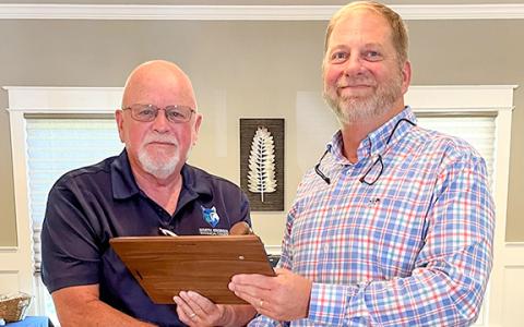 Outgoing chairman Mitchel Barrett passes the gavel to incoming chairman Gilbert Barrett. (Photo/submitted)