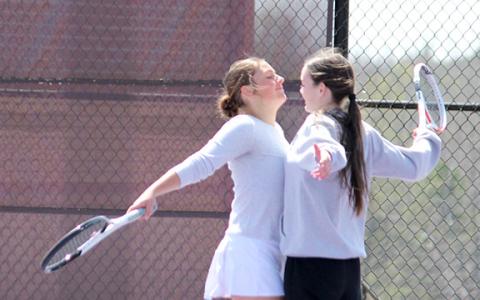 Linsey Burke, left, and Sarah Blair celebrate moments after winning the No. 2 doubles match against Pickens Tuesday  in the first round of the 7-AAA tournament in Dahlonega. The win clinched the 3-2 win and gives the team its first-ever state tournament bid. (Photo/Mark Turner)