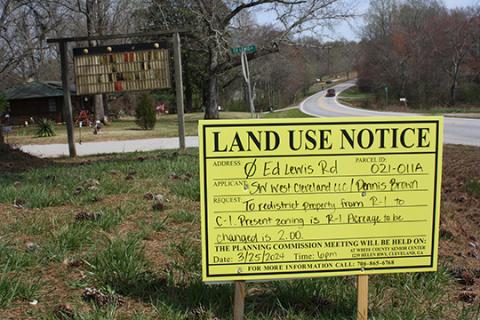 A sign placed off of Ed Lewis Road gives information about the public hearing. A Dollar General store is proposed for the property, requiring a zoning change. (Photo/Eric Tiongson)