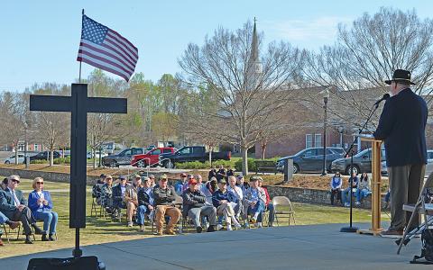 Col. Cal Riley, a combat veteran, shares his memories of the Vietnam War as a crowd of about 60 people listen. (Photos/Samantha Sinclair)