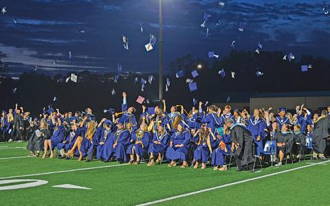 The Class of 2024 tosses their caps in the air Friday night moments after Principal Mary Anne Collier sends them off by saying, “Class dismissed.” (Photo/Samantha Sinclair)