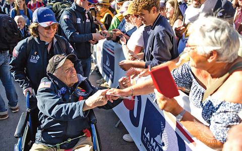 Virginie Durr helps Andy Negra meet his fans at the Ste Mere Eglise Parade on June 9. (Photo/Jerome Pollos Photography)