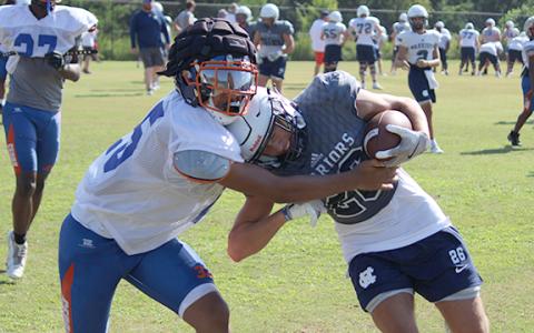 White County's Bryson Philyaw, right, collides with a Cedar Shoals defender after making a catch during the opening day of the Cherokee Bluff padded camp (Photo/Mark Turner)