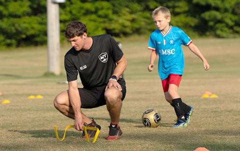 Evan Windham, left, sits up a drill for Wyatt Rickman during the event last week at the Tesnatee Sports Complex. (Photo/Submitted)