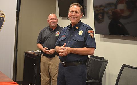 As Public Safety Director David Murphy smiles along in the background, Fire Chief Michael LeFevre shares his joy of having served White County. (Photo/Samantha Sinclair)