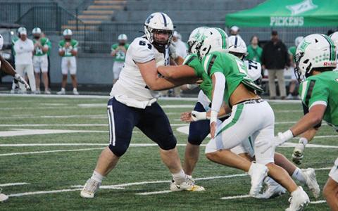 WCHS center Tyler Seymour holds off a couple of Pickens' defensive lineman during the Warriors' region win last week in Jasper. (Photo/Mark Turner)