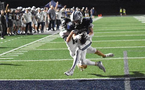 Zach Godrey drags North Hall defender into the end zone for a WCHS touchdown during the region battle last Friday in Cleveland..  (Photo/Basil Ray)