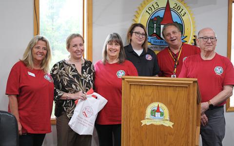 Fundraisers Doris Skelton, Pam Summers, Jessica Wood, Randy Summers and Dennis Doll present Helen Police Chief Aletha Barrett with money raised for the White Christmas for Kids fund at the Helen City Commission meeting. (Photo/Eric Tiongson)