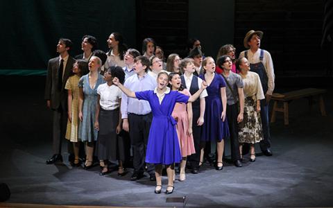 Sarah Wilkinson (front, blue dress) performs the song “If You Knew My Story” at the beginning of the ‘Bright Star’ theater play with the entire cast. Wilkinson plays the main character, Alice Murphy. (Photo/Hannah Caudell)