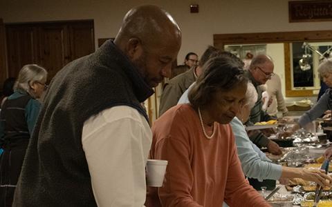 Andy and Stacy Allen, Inda Allen’s brother and mother, go through the potluck buffet. (Photo/Hannah Caudell)