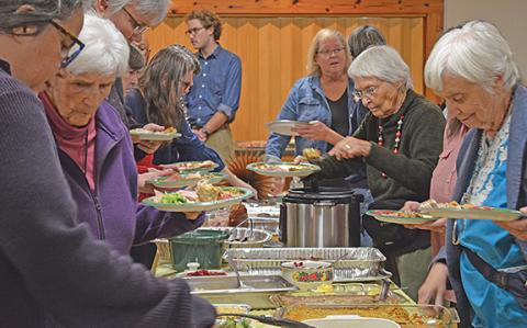 Guests fill their plates with food at last year’s Annual Thanksgiving Dinner at the Sautee Nacoochee Center. (Photo/Samantha Sinclair)
