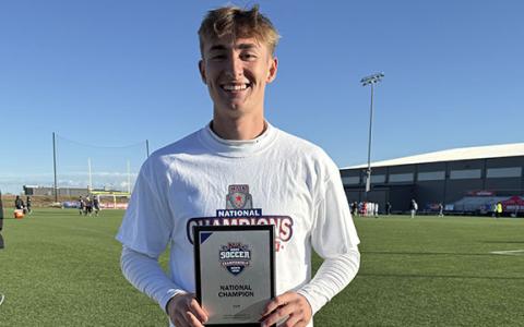 Iyan Windham shows off the NAIA plaque after national championship game Monday in Kansas.  (Photo/Submitted)