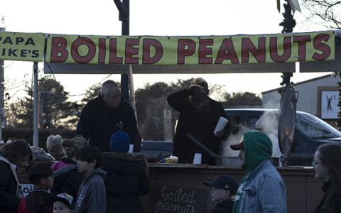 From left, Mike “Papa Mike” Meaders and Tim Thomas serve up boiled peanuts to a hungry crowd of evening shoppers at the Christmas in Mountains Market on Dec. 7. (Photo/Hannah Caudell)
