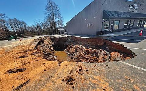 The sinkhole that opened up in a parking lot between Dalton Eye Car and Anytime Fitness. (Photo/Basil Ray)