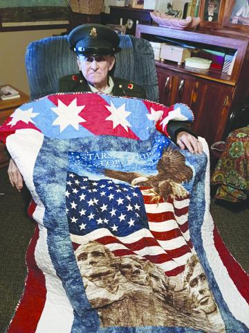 James Sutton wore his original uniform for the ceremony, in which the quilt was draped around him. (Photo/Submitted)