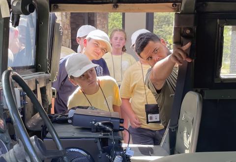 A special operations officer with the White County Sheriff's Office gives local kids an inside look at an armored SWAT vehicle. (Staff photo/Jerry Grillo)