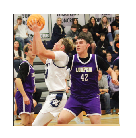 White County's Champ McCutcheon, left, puts up a shot in front of Lumpkin County's Brett Passmore during the eighth grade game Tuesday afternoon at WCMS. MARK TURNER /WCN