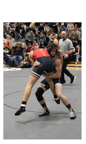 Josh Lane picks up a Stephens County wrestler during the Warriors' win over the Indians on Senior Night. MARK TURNER/WCN.