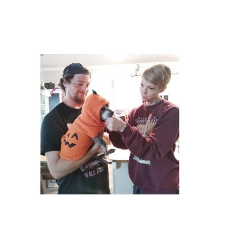 Michael and Katlyn Etheridge dress Caesar like a pumpkin for Halloween. DENISE ETHERIDGE/WCN