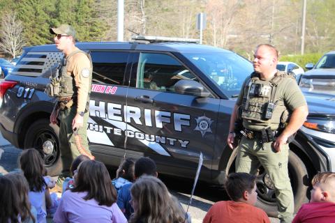 Deputies Zack Lathem, left, and Deputy and School Resource Officer Dylan Loggins, right, (and K-9 Jelly) speak with students and answer questions during Career Day. PHOTOS BY CARLY HENDERSON/WCN
