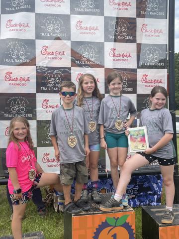 Shown on the podium after the final event of the season are, from left, Faith Hogan, Paxton Swanzy, Mercy Hogan, Reagan Phillips and Connect Award Winner Grace Meinecke. 