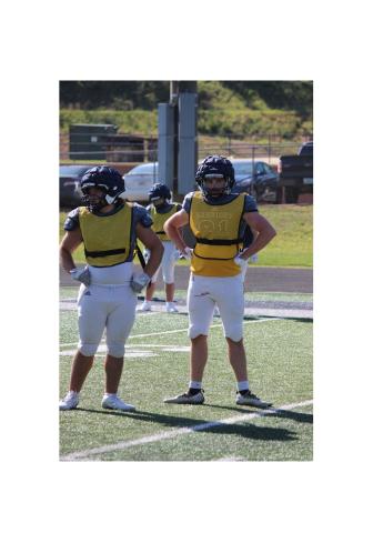 Mikey Moreno, left, and James Hart get a defensive call during the team's practice Tuesday afternoon at Warrior Stadium.  MARK TURNER/WCN