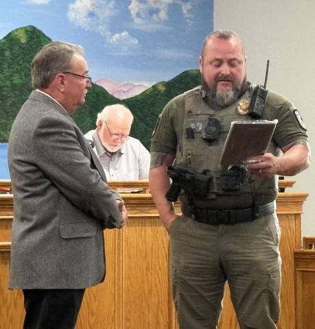Sgt. Chris Barrett presents a retirement award to Officer William “Rice” Poteat during the June 16 City of Helen Commission meeting recognizing Poteat’s years of service with the Helen Police Department. CARLY HENDERSON/WCN